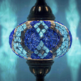 Lit close-up of mosaic glass globe — Blue table lamp glowing (ENV MUN3053)