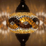 Lit close-up of mosaic glass globe — Amber table lamp glowing (ENV MUN3064)