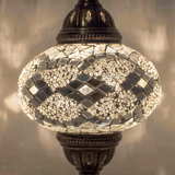 Lit close-up of mosaic glass globe — White table lamp glowing (ENV MUN3068)
