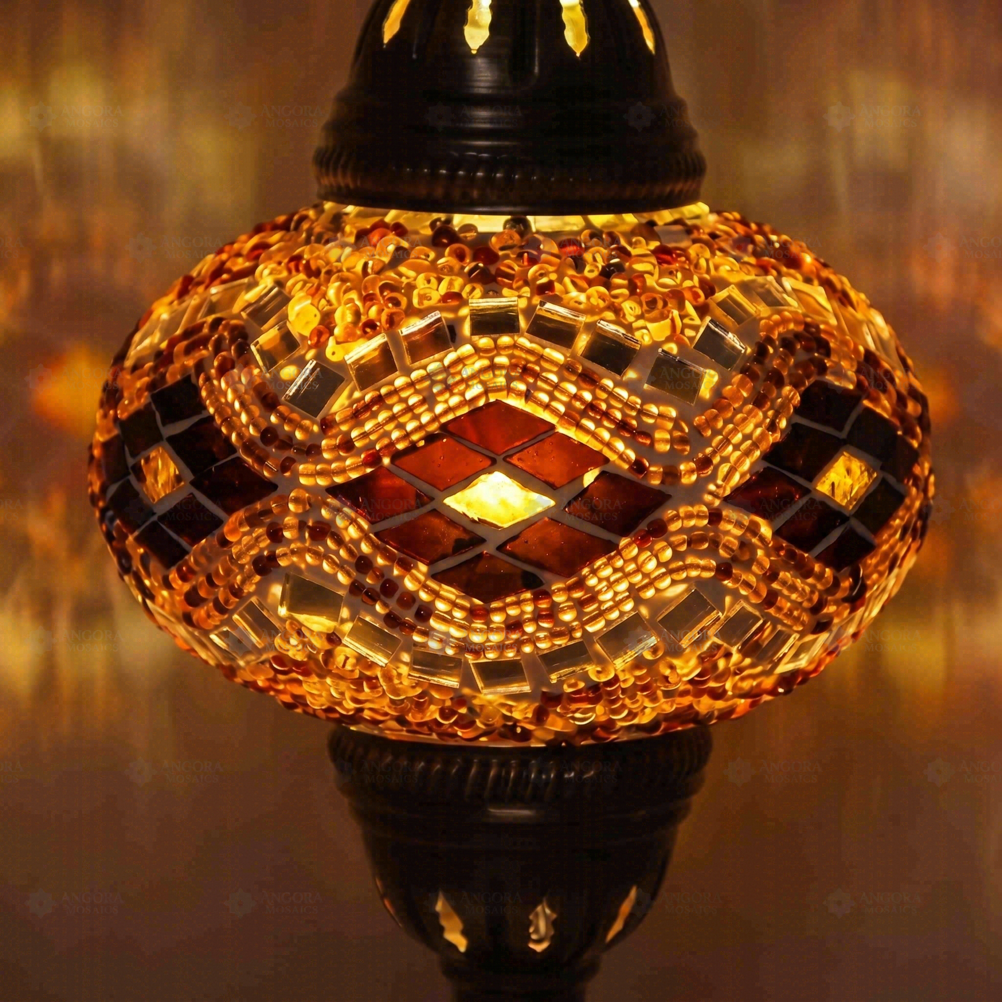 Lit close-up of mosaic glass globe — Amber table lamp glowing (ENV MUN3097)