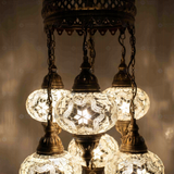Lit close-up of mosaic glass globe — White chandelier glowing (ENV SLT7N3 (3015))