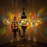 Multicolor Turkish mosaic wall sconce illuminated, showing colorful light projection (ENV APN2008)