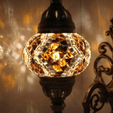 Lit close-up of mosaic glass globe — Amber wall sconce glowing (ENV APN2025)