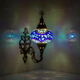 Blue Turkish mosaic wall sconce illuminated, showing colorful light projection (ENV APN3005)