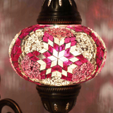 Lit close-up of mosaic glass globe — Pink wall sconce glowing (ENV APN3008)