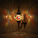Multicolor Turkish mosaic wall sconce illuminated, showing colorful light projection (ENV APN3017)