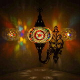Multicolor Turkish mosaic wall sconce illuminated, showing colorful light projection (ENV APN3021)