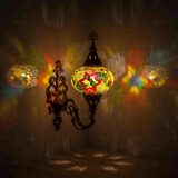 Multicolor Turkish mosaic wall sconce illuminated, showing colorful light projection (ENV APN3024)