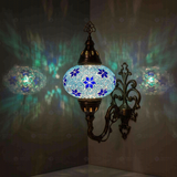 Blue Turkish mosaic wall sconce illuminated, showing colorful light projection (ENV APN3027)