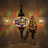 Multicolor Turkish mosaic wall sconce illuminated, showing colorful light projection (ENV APN3029)