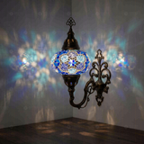 Blue Turkish mosaic wall sconce illuminated, showing colorful light projection (ENV APN3034)
