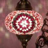 Lit close-up of mosaic glass globe — Pink wall sconce glowing (ENV APN3044)