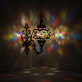 Multicolor Turkish mosaic wall sconce illuminated, showing colorful light projection (ENV APN3047)