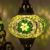 Lit close-up of mosaic glass globe — Green wall sconce glowing (ENV APN3050)