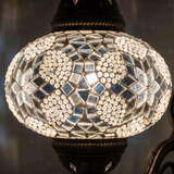 Lit close-up of mosaic glass globe — White wall sconce glowing (ENV APN3054)