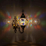 Multicolor Turkish mosaic wall sconce illuminated, showing colorful light projection (ENV APN3060)