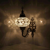 White Turkish mosaic wall sconce illuminated, showing colorful light projection (ENV APN3068)