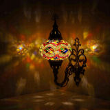 Multicolor Turkish mosaic wall sconce illuminated, showing colorful light projection (ENV APN3074)
