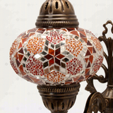 Close-up of Amber warm amber mosaic glass globe pattern — wall sconce (ENV APN3079)