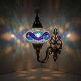Blue Turkish mosaic wall sconce illuminated, showing colorful light projection (ENV APN3094)