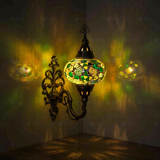 Green Turkish mosaic wall sconce illuminated, showing colorful light projection (ENV APN3100)