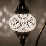 Lit close-up of mosaic glass globe — White table lamp glowing (ENV DVN2001)