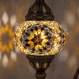 Lit close-up of mosaic glass globe — Amber table lamp glowing (ENV DVN2118)