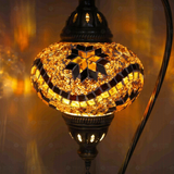 Lit close-up of mosaic glass globe — Amber table lamp glowing (ENV DVN3009)