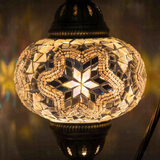 Lit close-up of mosaic glass globe — White table lamp glowing (ENV DVN3015)