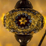 Lit close-up of mosaic glass globe — Amber table lamp glowing (ENV DVN3049)