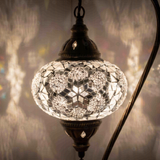 Lit close-up of mosaic glass globe — White table lamp glowing (ENV DVN3054)
