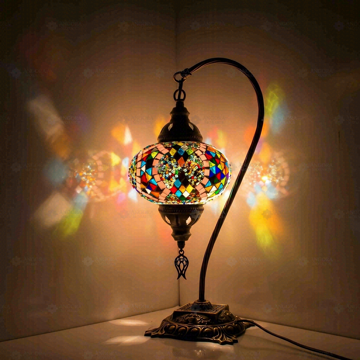 Multicolor Swan Neck Table Lamp, switched on, glowing in a dark room