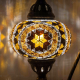 Lit close-up of mosaic glass globe — Amber table lamp glowing (ENV DVN3067)