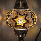 Lit close-up of mosaic glass globe — Amber table lamp glowing (ENV DVN3088)