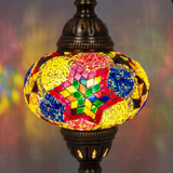 Lit close-up of mosaic glass globe — Multicolor table lamp glowing (ENV DVN3093)