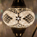 Lit close-up of mosaic glass globe — White table lamp glowing (ENV DVN3098)
