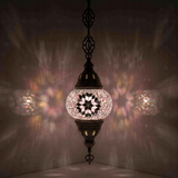 Pink Turkish mosaic pendant light illuminated, showing colorful light projection (ENV DYN1034)