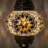Lit close-up of mosaic glass globe — Amber pendant light glowing (ENV DYN2118)
