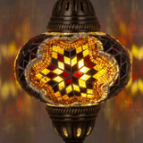 Lit close-up of mosaic glass globe — Amber pendant light glowing (ENV DYN3031)