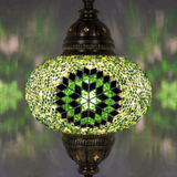 Lit close-up of mosaic glass globe — Green pendant light glowing (ENV DYN3048)