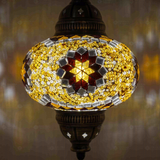 Lit close-up of mosaic glass globe — Amber pendant light glowing (ENV DYN3049)