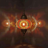 Amber Turkish mosaic pendant light illuminated, showing colorful light projection (ENV DYN3052)