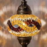 Lit close-up of mosaic glass globe — Amber pendant light glowing (ENV DYN3064)