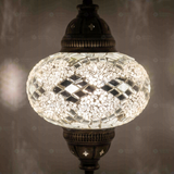 Lit close-up of mosaic glass globe — White pendant light glowing (ENV DYN3068)