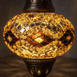 Lit close-up of mosaic glass globe — Amber pendant light glowing (ENV DYN3097)