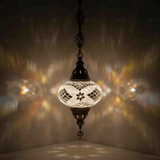 White Turkish mosaic pendant light illuminated, showing colorful light projection (ENV DYN3098)