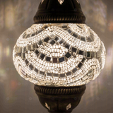 Lit close-up of mosaic glass globe — White table lamp glowing (ENV MUN2001)