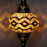 Lit close-up of mosaic glass globe — Warm Tones table lamp glowing (ENV MUN3013)