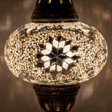 Lit close-up of mosaic glass globe — White table lamp glowing (ENV MUN3022)