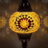 Lit close-up of mosaic glass globe — Amber table lamp glowing (ENV MUN3026)